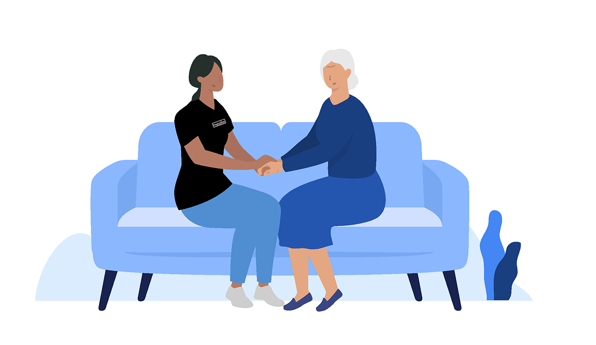 client and support worker sitting on chair chatting together
